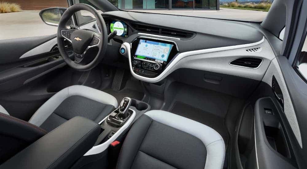 The gray and black interior and dashboard of a 2019 Chevy Bolt EV are shown.