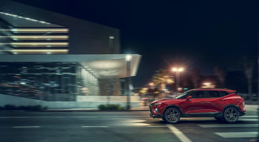 A red 2019 Chevy Blazer RS is shown from the side driving through the city.