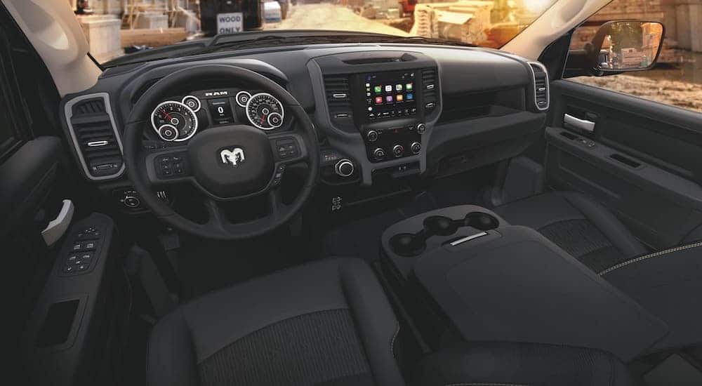 A popular work truck for sale near you, a 2021 Ram 2500, is showing the black steering wheel and interior.