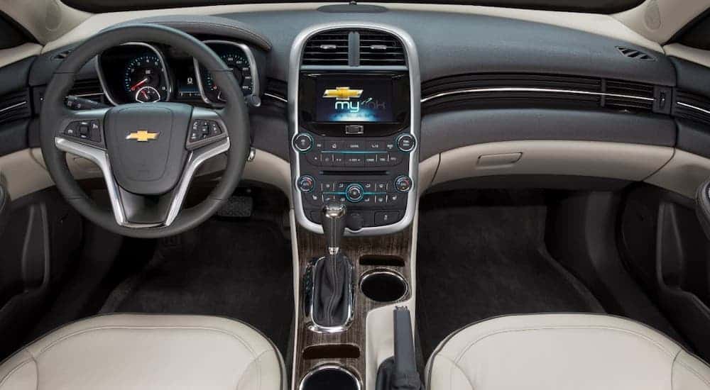 The gray and black dashboard and interior are shown in a 2021 Chevy Malibu.