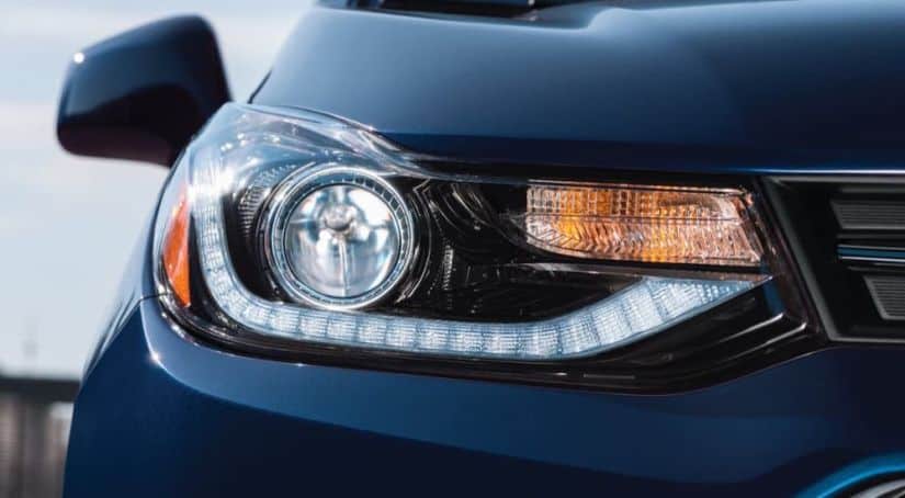 A closeup shows the headlight on a blue 2021 Chevy Trax as part of the 2021 Chevy Trax vs 2021 Ford EcoSport comparison.