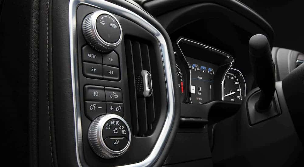 A close up shows the gauge cluster and controls in a 2021 GMC Sierra 1500.