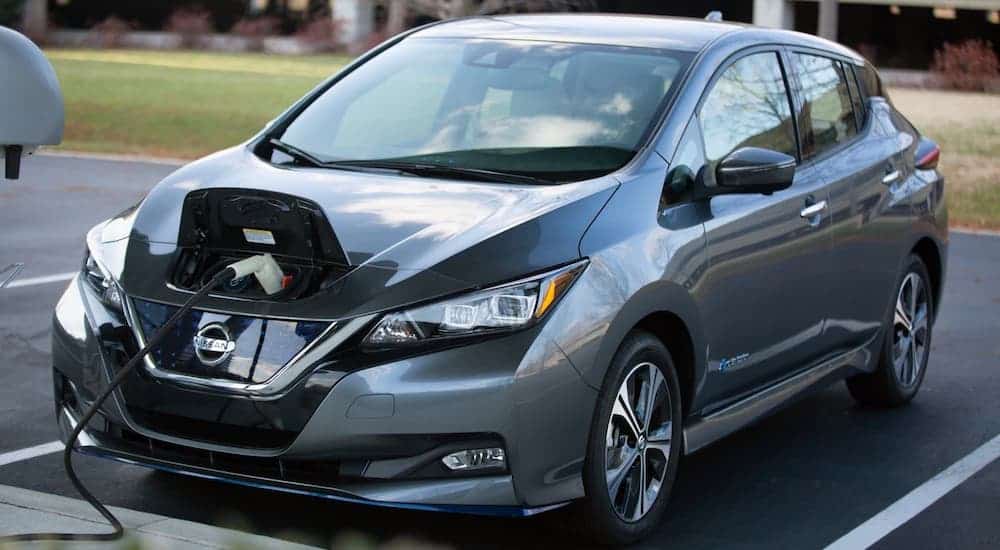 A gray 2021 Nissan LEAF is being charged.