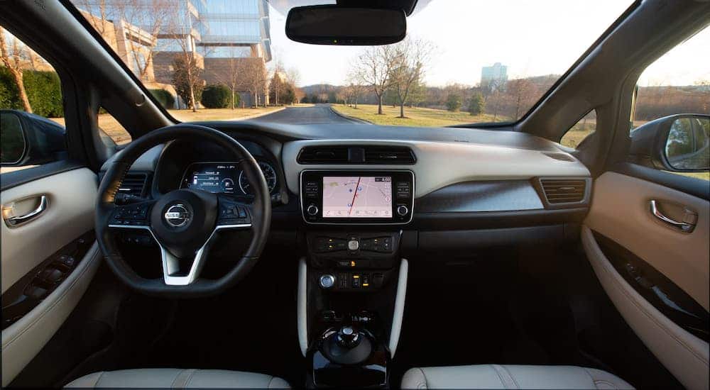 A view of the dashboard and gray interior of a 2021 Nissan LEAF is shown.