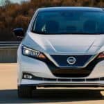 A white 2021 Nissan LEAF is shown from the front.