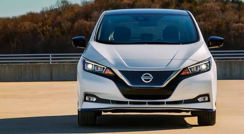 A white 2021 Nissan LEAF is shown from the front.