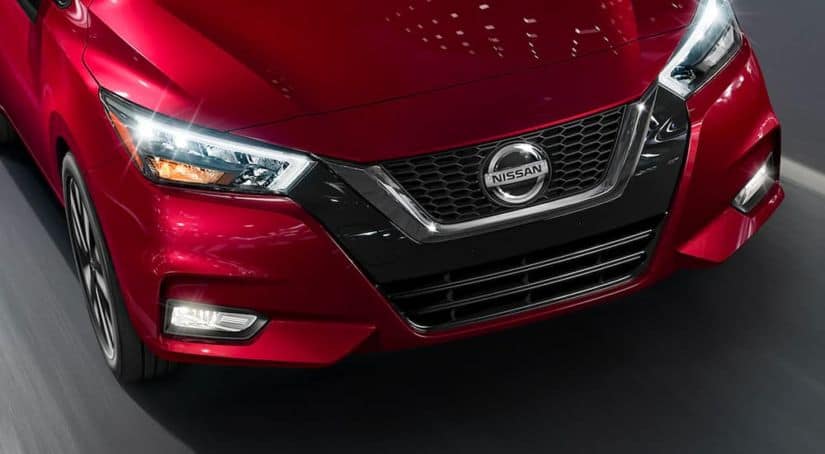 A close up shows the front end of a 2021 Nissan Versa from a high angle.