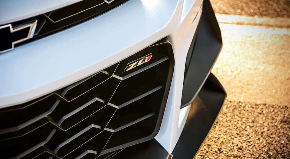 A close up shows the lower grill and ZL1 emblem on a white 2019 Chevy Camaro ZL1.