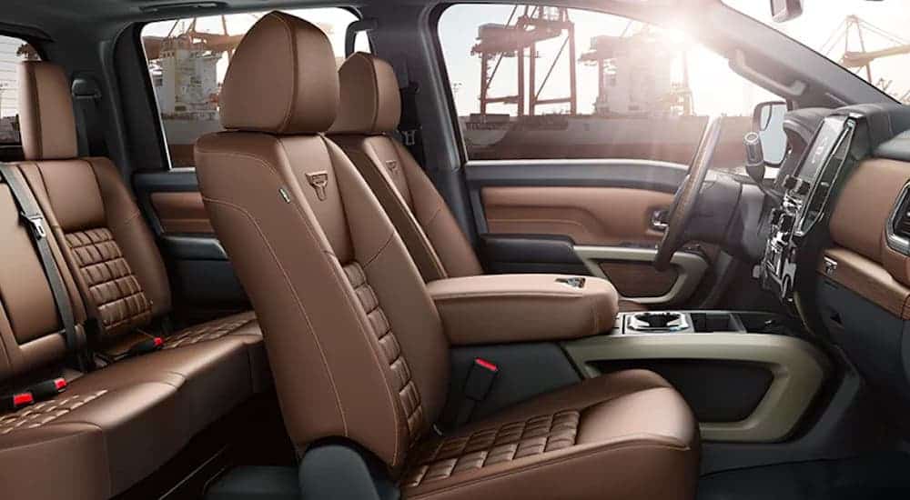 The brown interior is shown from the passenger side in a 2021 Nissan Titan.