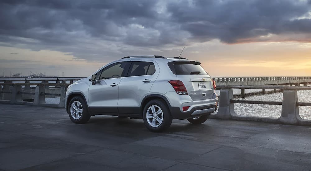 A silver 2021 Chevy Trax is parked next to a jetty.