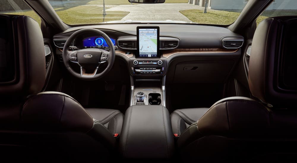 The brown leather seats, dashboard and infotainment screen are shown in a 2021 Ford Explorer.