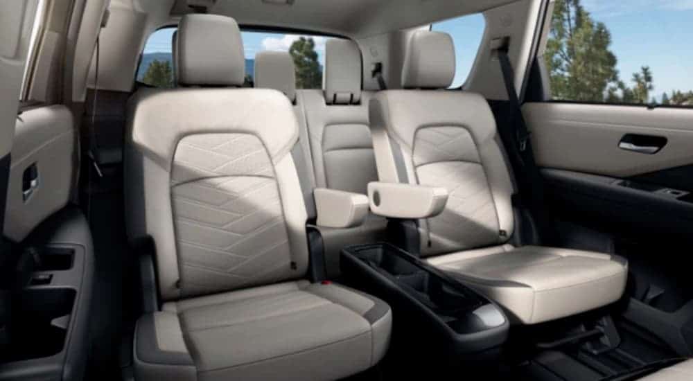 The rear two rows of white seating are shown in a 2022 Nissan Pathfinder.