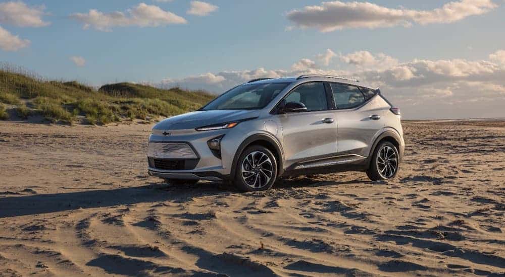 A silver 2022 Chevy Bolt EUV is parked on a beach.