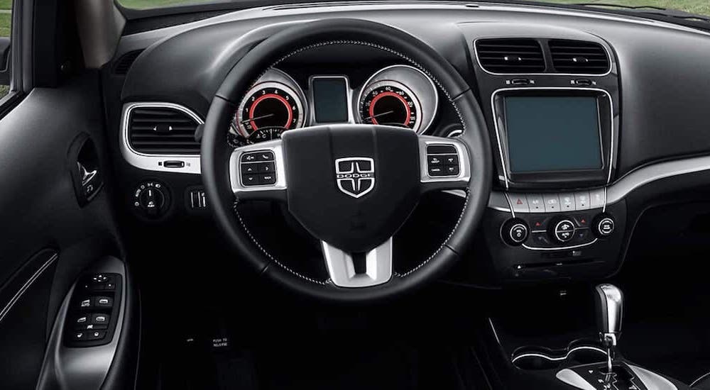 The black and silver interior is shown in a 2020 used Dodge Journey.