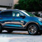 A blue 2021 Buick Encore GX is parked in a driveway aftr winning a 2021 Buick Encore GX vs 2021 Hyundai Kona comparison.