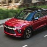 A red 2021 Chevy Trailblazer is shown from the side driving down an open road.