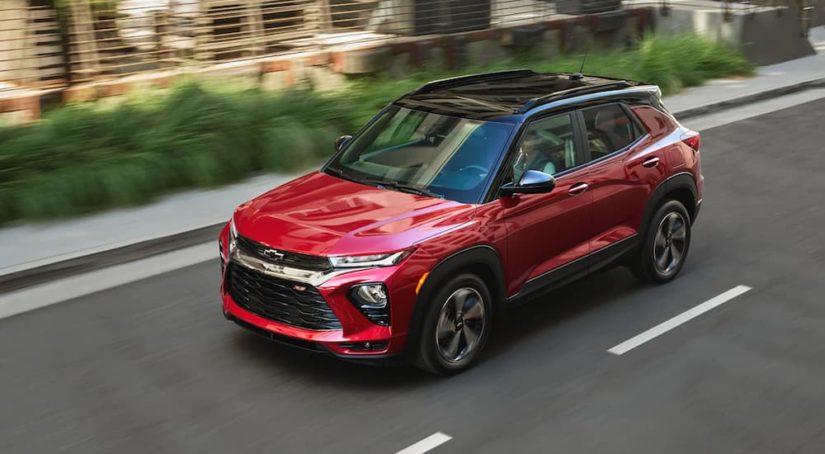 A red 2021 Chevy Trailblazer is shown from the side driving down an open road.