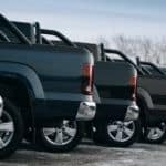 A row of truck beds is shown from the side at a Houston used truck dealer.