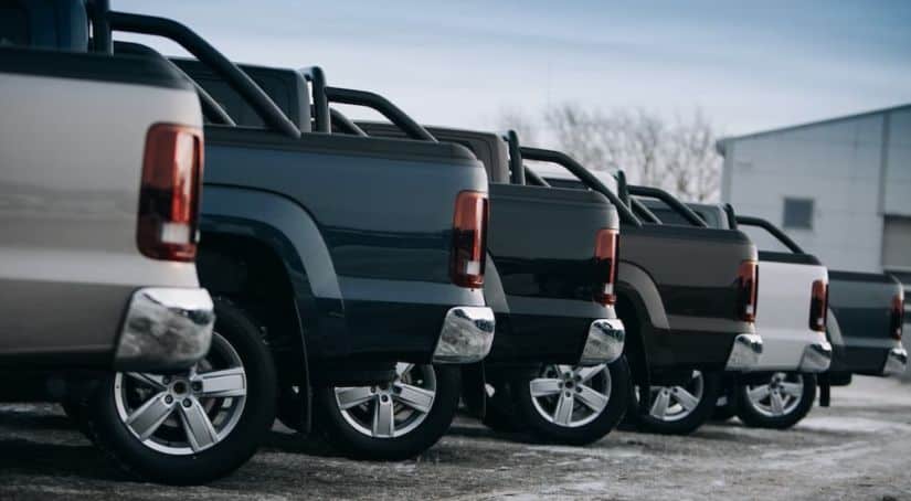 A row of truck beds is shown from the side at a Houston used truck dealer.