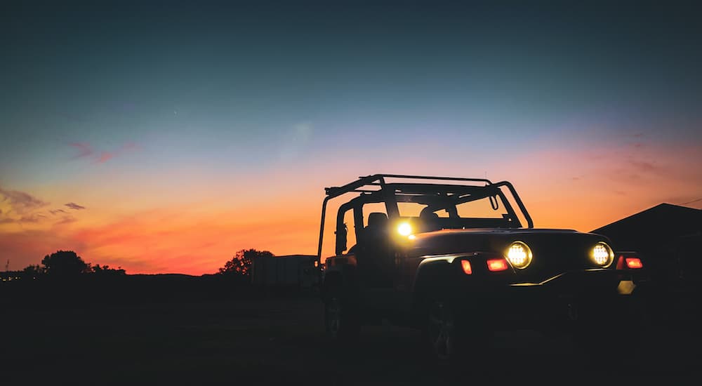 A 2005 Jeep Wrangler Rubicon is shown during a sunset after viewing a Used Jeep Wrangler buyer’s guide.