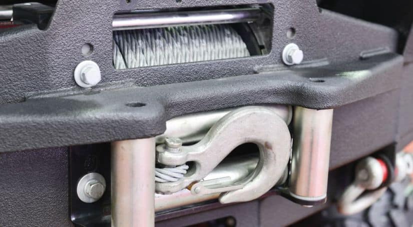 A close up shows the front winch on a 2015 used Jeep Wrangler Rubicon.