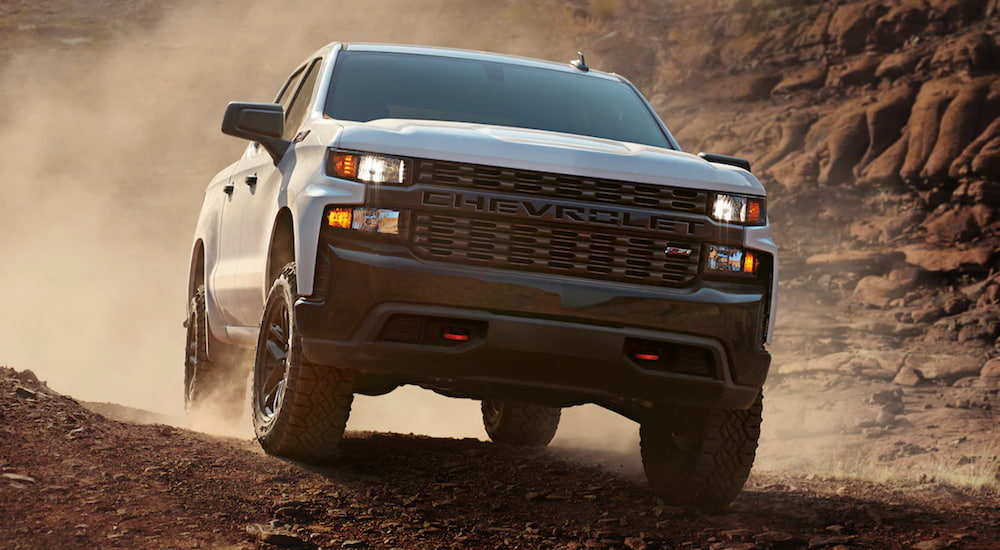 A 2020 Chevy Silverado is driving off-road in the mountains.