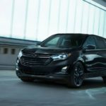 A black 2021 Chevy Equinox is driving through a tunnel after winning a 2021 Chevy Equinox vs 2021 Honda CR-V comparison.