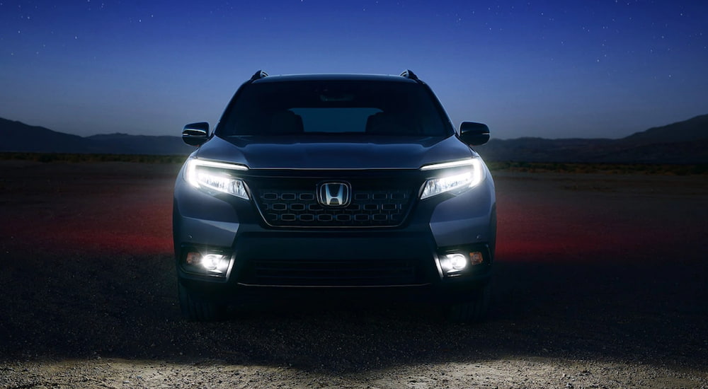A 2021 Honda Passport is shown from the front at night.