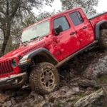 A red 2021 Jeep gladiator is driving down a rock pile after winning a 2021 Jeep Gladiator vs 2021 Chevy Colorado comparison.