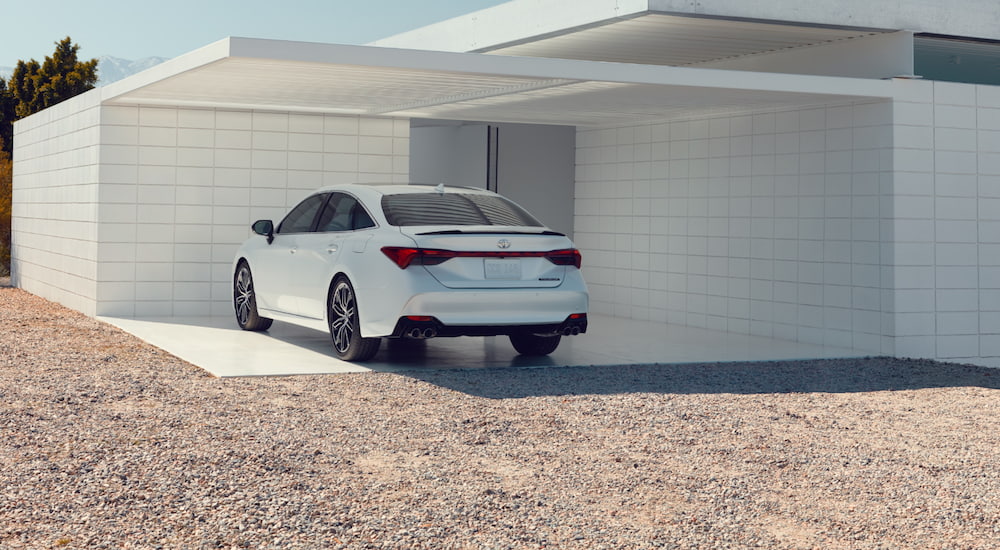 A white 2021 Toyota Avalon is parked in a modern garage.