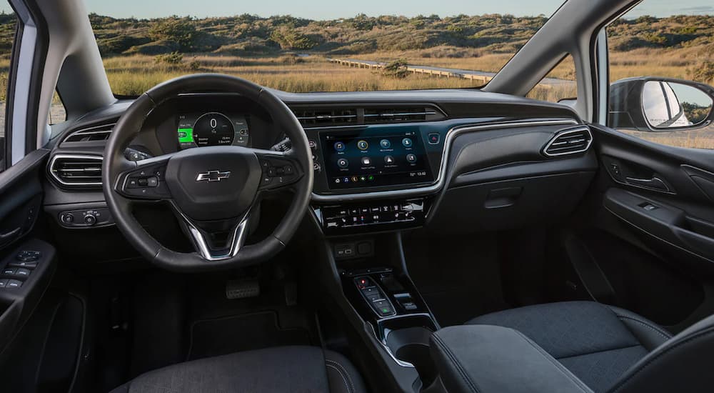 The interior of a 2022 Chevy Bolt EV shows the steering wheel and infotainment screen.