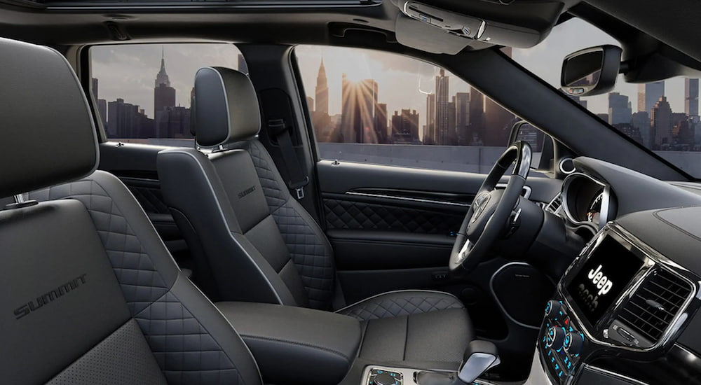 The interior of a 2021 Certified Pre-Owned Jeep Grand Cherokee shows the front seats and steering wheel.