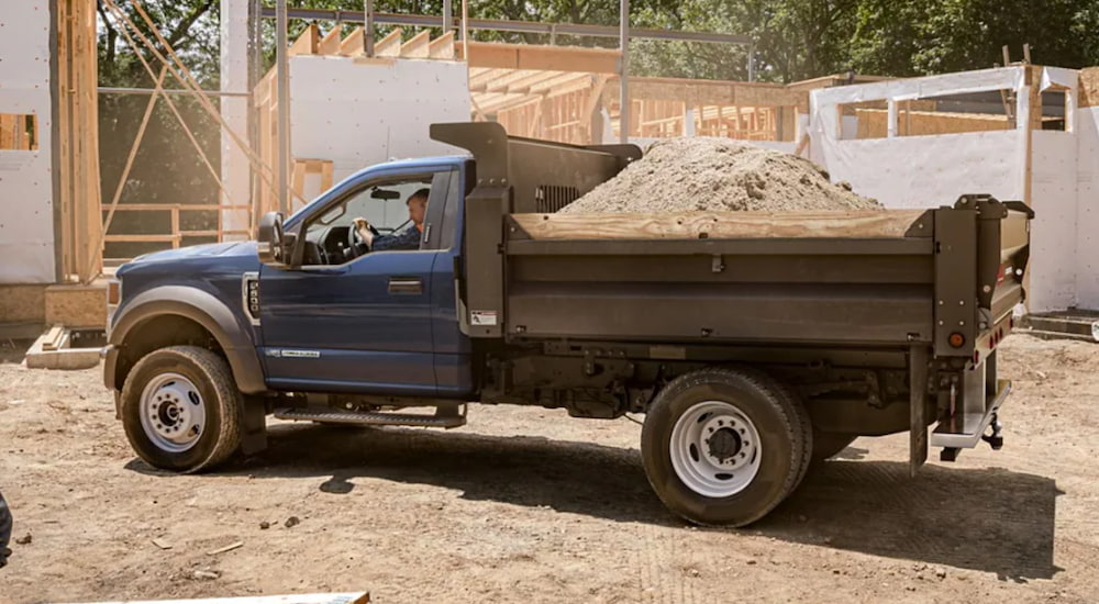 A 2021 Ford F-600 Chassis Cab is being used to haul sand.