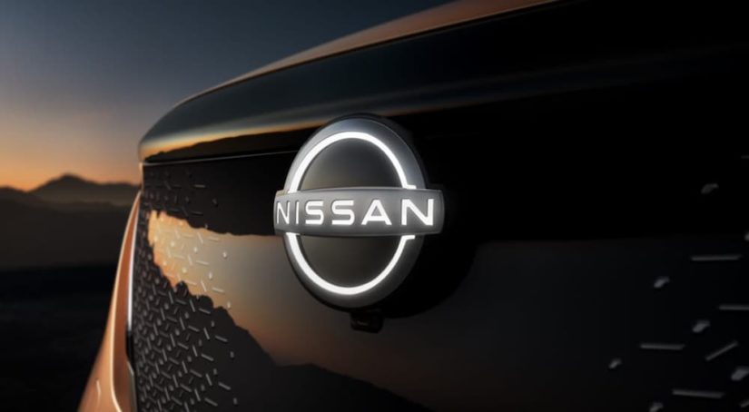 A 2021 Nissan Ariya emblem is ahown at night after leaving a Nissan dealer.