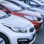 A row of parked cars that await online car sales.