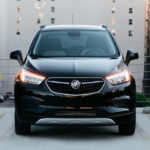 A black 2020 Buick Encore is shown from the front parked on a city roof after leaving a used Buick Dealership.