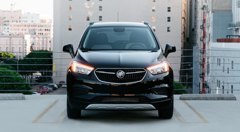 A black 2020 Buick Encore is shown from the front parked on a city roof after leaving a used Buick Dealership.