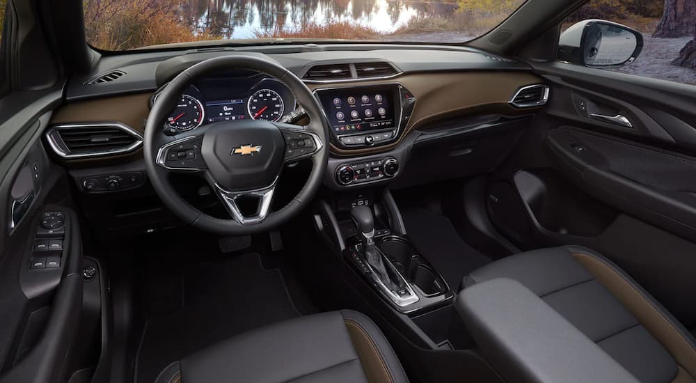 The interior of a 2021 Chevy Trailblazer shows the steering wheel and infotainment screen.