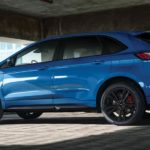 A light blue 2021 Ford Edge is shown from the side parked in a parking garage.