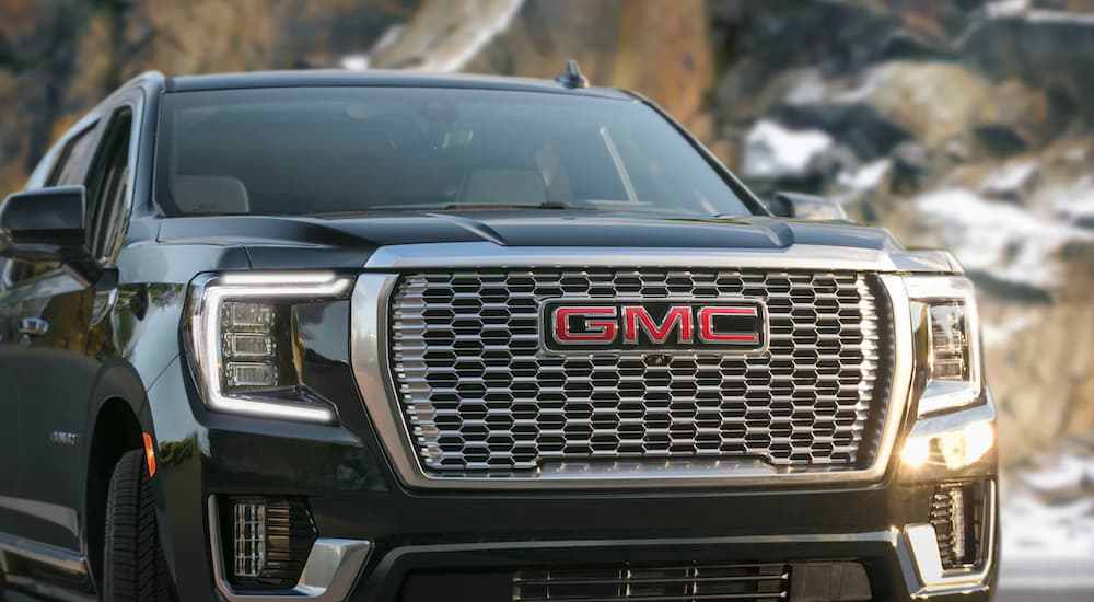 A close up of a black 2021 GMC Yukon shows the grille.