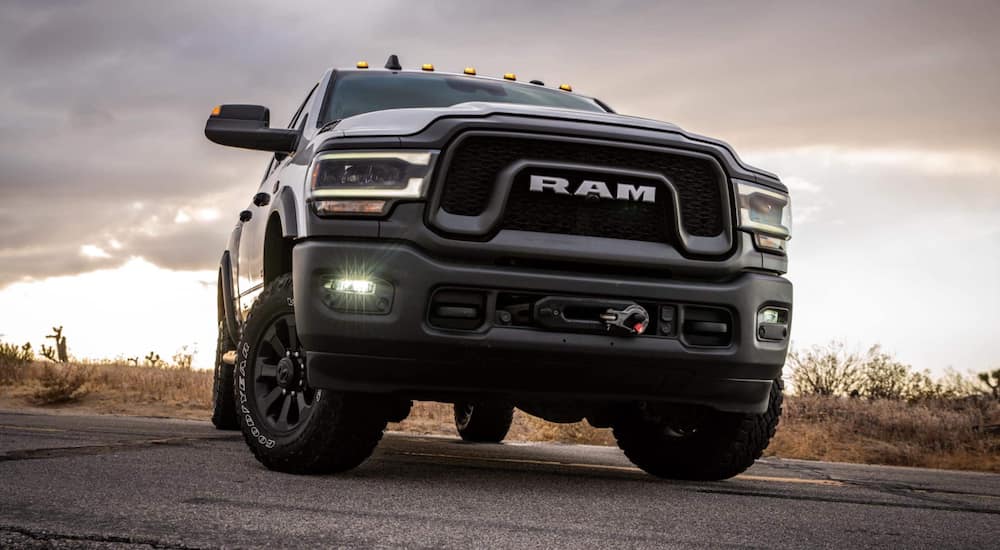 A black 2021 Ram 2500 is shown from the front at a low angle parked on cement.