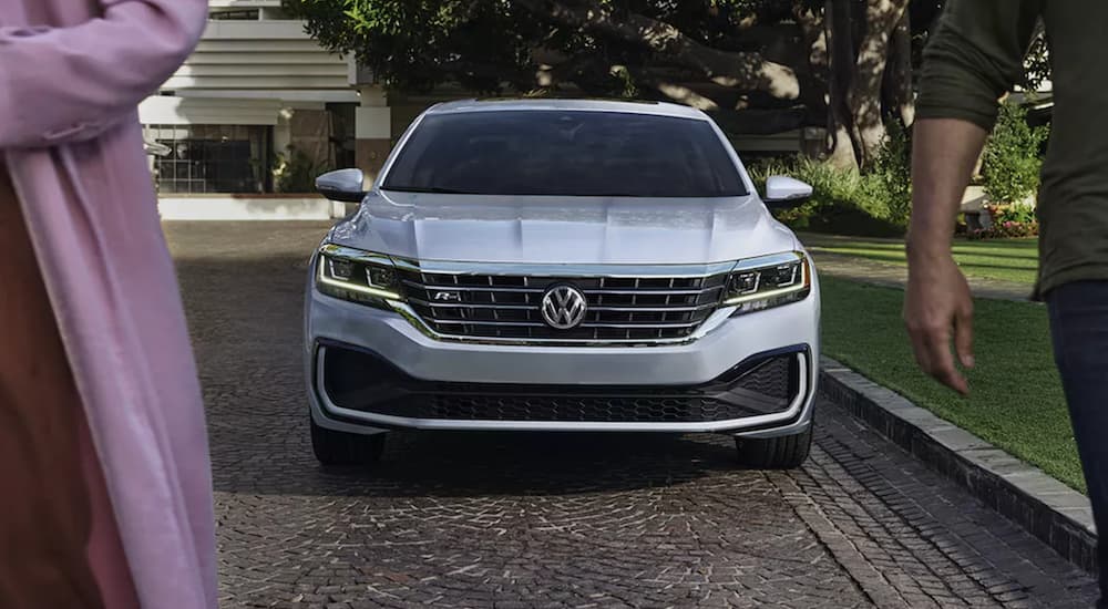 The front of a 2021 Volkswagen Passat R-Line is shown parked on brick driveway.