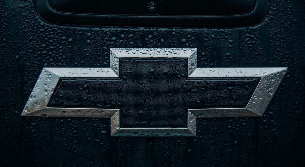 A Chevy Silverado bowtie is shown in the rain.
