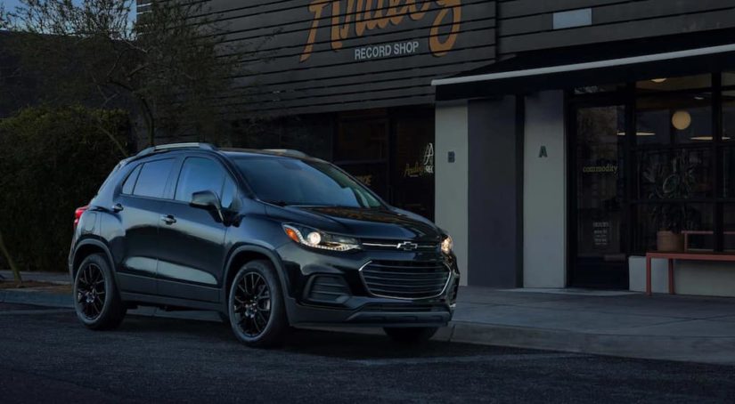 A black 2021 Chevy Trax is parked outside of record store after leaving a Chevy crossover dealer.