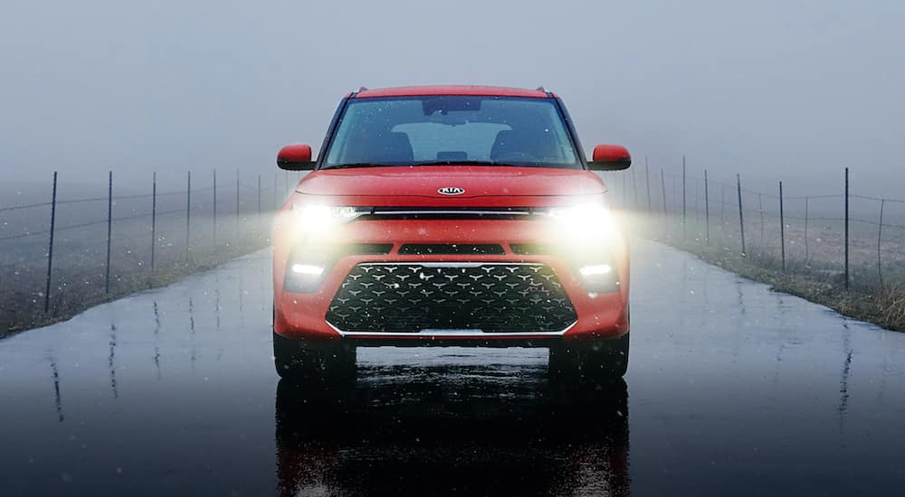 The front of a red 2021 Kia Soul is shown in the rain after leaving a Kia Soul dealer.