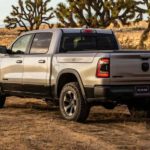 A silver 2021 Ram 1500 is shown from the side parked in a desert.