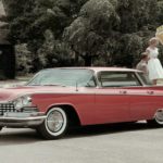 A red 1959 Buick LeSabre is parked in a driveway.