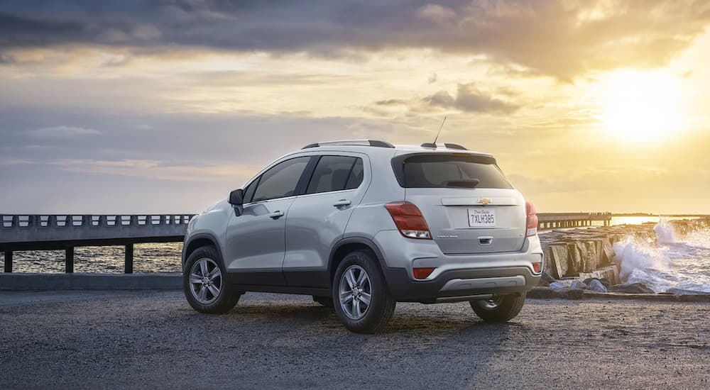 A white 2021 Chevy Trax is parked on a jetty at sunset.