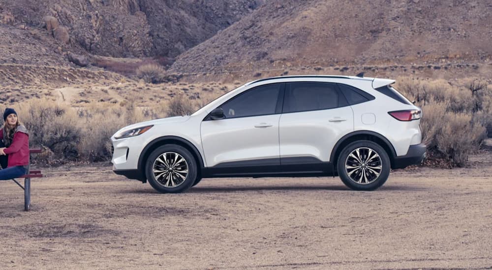 A white 2021 Ford Escape is shown from the side parked in a desert.