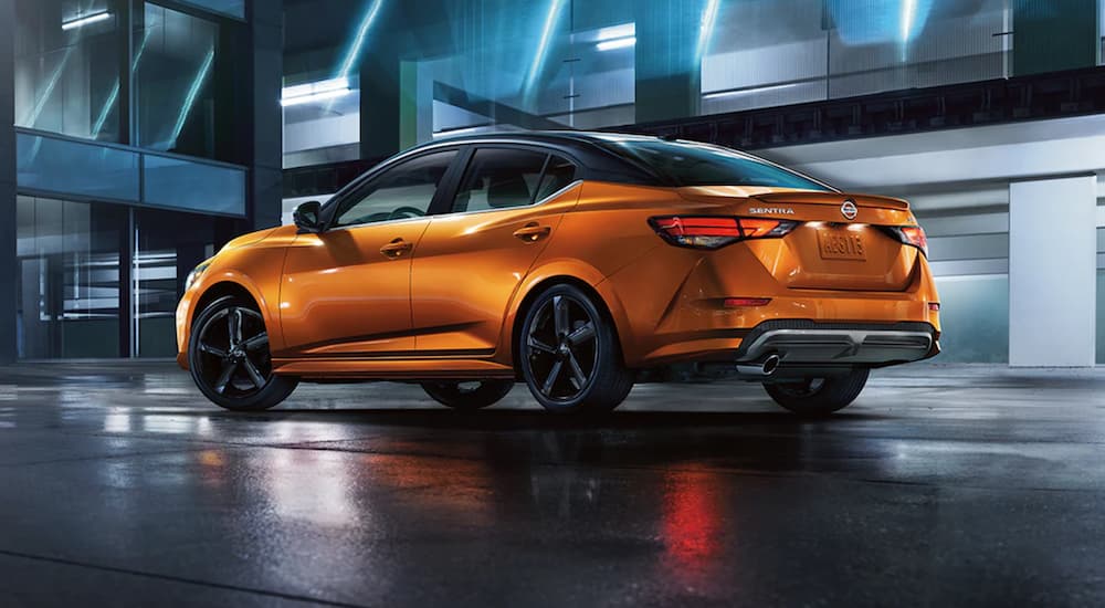 An orange 2021 Nissan Sentra is shown from the side parked at night.